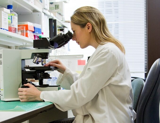 woman in white robe sitting on black office rolling chair